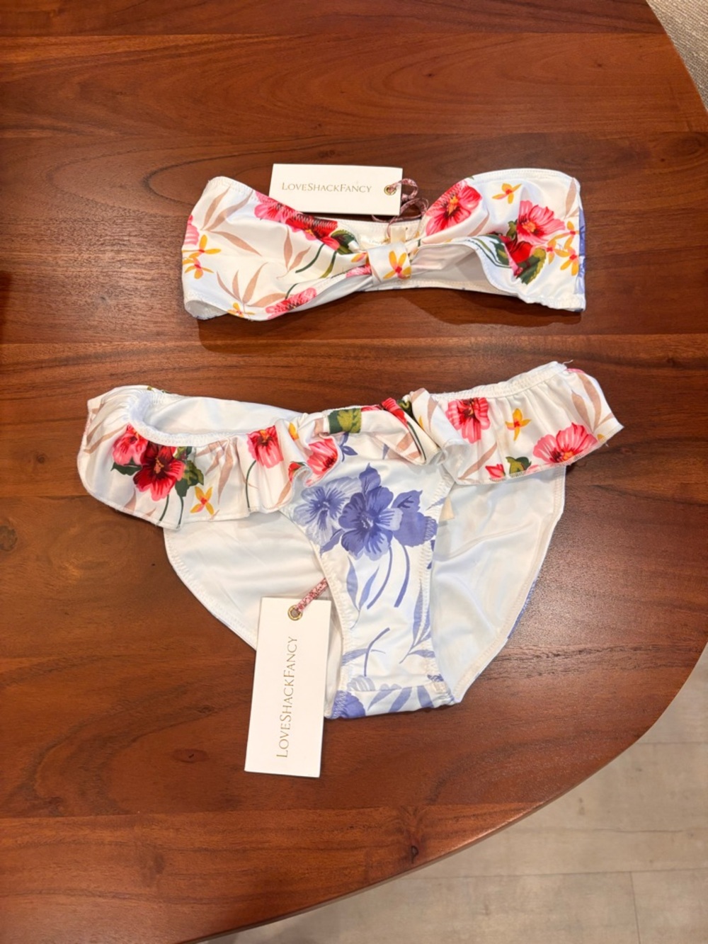 LoveShackFancy White Floral Ruffle Bikini Set with Pink, Red, Purple Accents.